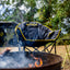 burning campfire in front of folding chair