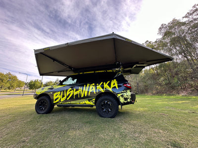 rooftop tent open and attached to black 4wd with bushwakka branding